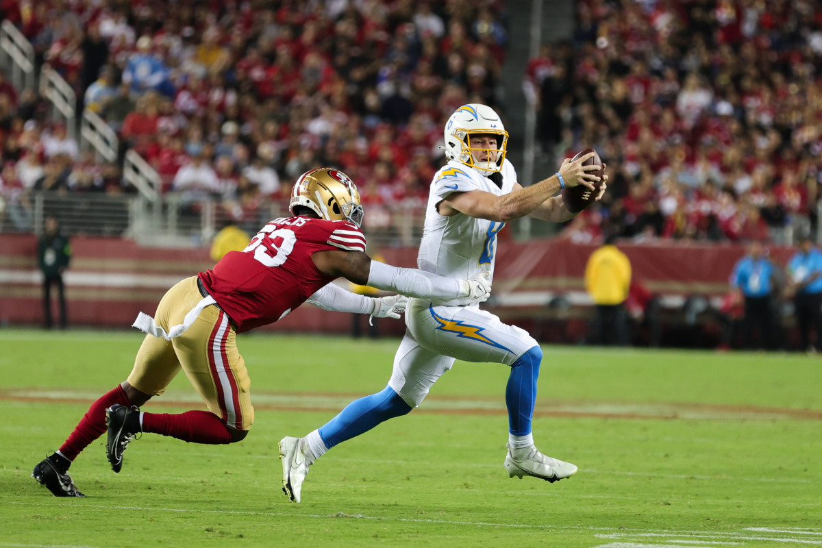 Aug 25, 2023; Santa Clara, California, USA; Los Angeles Chargers quarterback Max Duggan (8) avoids San Francisco 49ers linebacker Dee Winters (53) during the third quarter at Levi's Stadium. Mandatory Credit: Sergio Estrada-USA TODAY Sports  